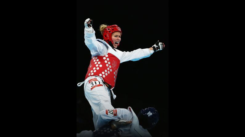 Finland's Suvi Mikkonen, left, spars with Senegal's Bineta Diedhiou during the preliminary round women's under 57-kilogram taekwondo match.
