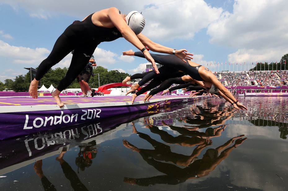 Germany's  Angela Maurer, left, and and Spain's Erika Villaecija Garcia dive in to start the women's marathon 10-kilometer swimming.