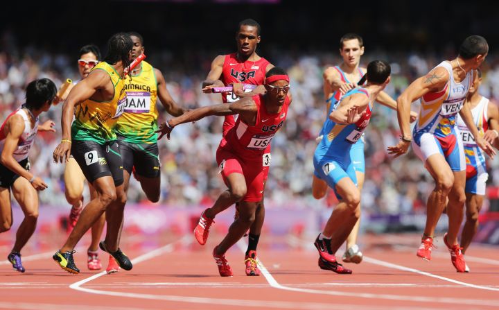 U.S. runner Joshua Mance passes the baton to teammate Tony McQuay during the men's 4 by 400-meter relay round 1 heats.