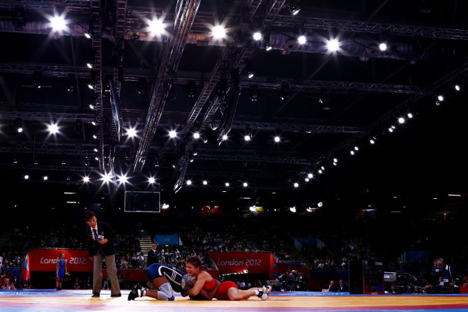 Great Britain's Olga Butkevych, right, and Ecuador's Lissette Alexandra Antes Castillo compete in the women's freestyle 55-kilogram wrestling.