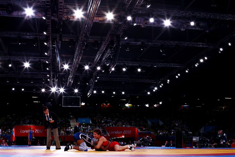 Great Britain's Olga Butkevych, right, and Ecuador's Lissette Alexandra Antes Castillo compete in the women's freestyle 55-kilogram wrestling. 