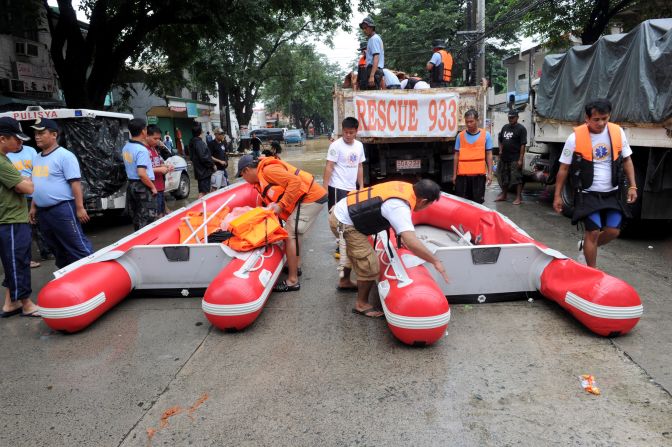 Philippine police rescue teams prepare boats to evacuate residents in a suburb of Manila.