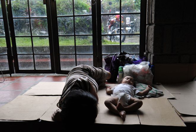 Displaced residents rest at an evacuation center inside a church in suburban Manila.