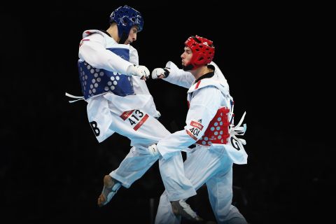 Great Britain's Martin Stamper, right, spars with Serbia's Damir Fejzic in the men's under-68-kilogram taekwondo quarterfinal match.