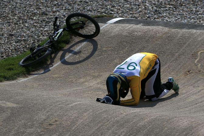 Australian rider Khalen Young lies on the ground after crashing during the men's BMX cycling quarterfinals.