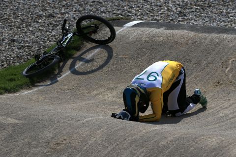 Australian rider Khalen Young lies on the ground after crashing during the men's BMX cycling quarterfinals. 