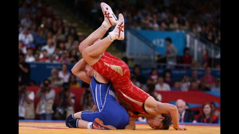 Japan's Saori Yoshida, right, and Azerbaijan's Yuliya Ratkevich compete in the women's freestyle 55-kilogram wrestling.