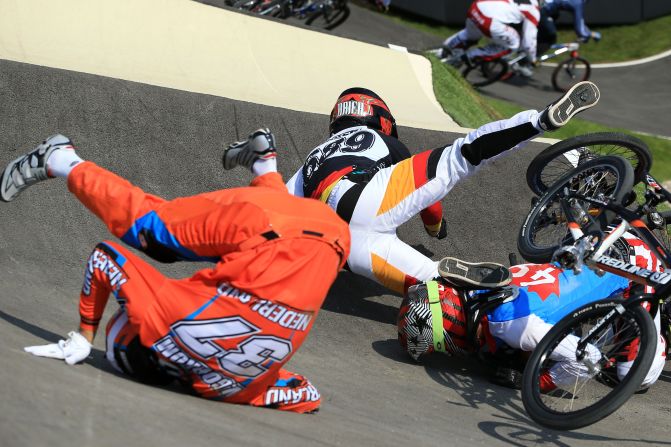 Dutch rider Jelle Van Gorkom, from left, German Maik Baier and Canadian Tory Nyhaug crash during the men's BMX cycling quarterfinals. 