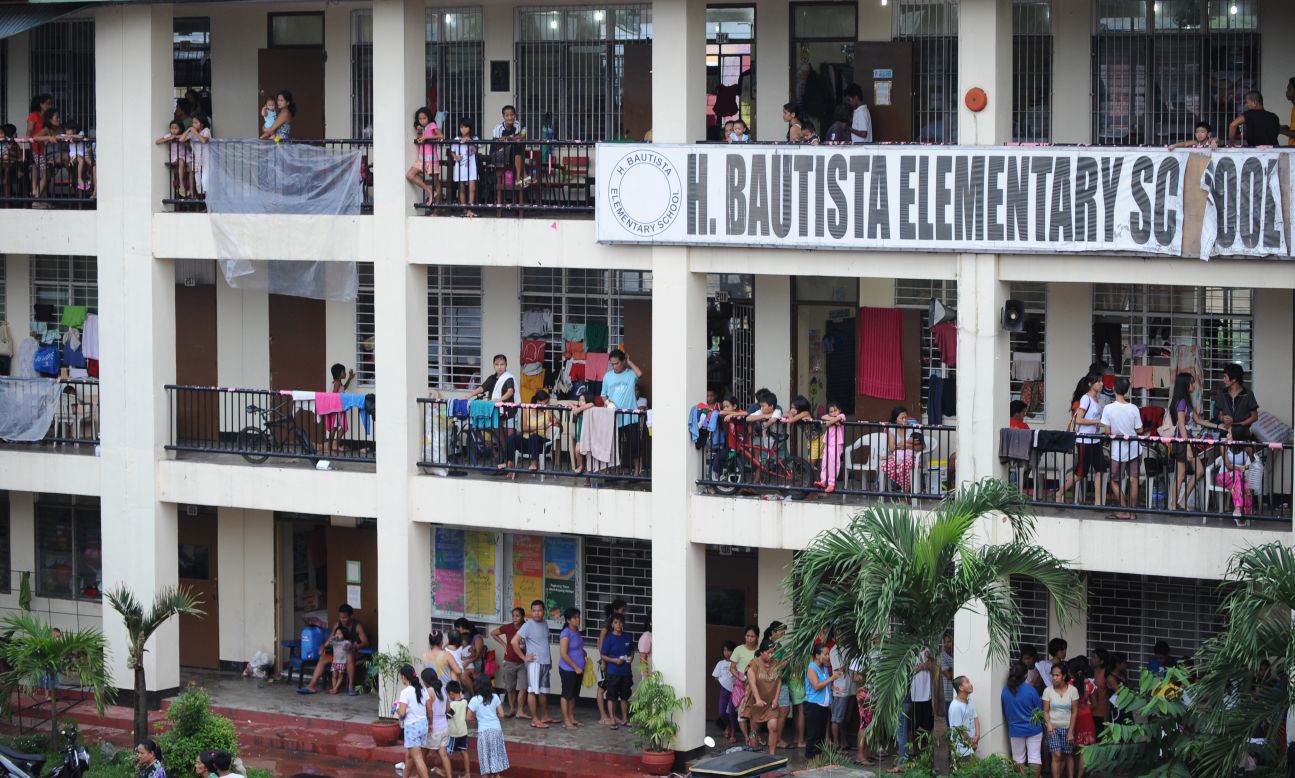 Residents of Marikina City in suburban Manila fill a school building serving as a flood evacuation center on Thursday. 