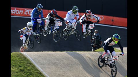 Nicholas Long of the United States, right, leads the field during the men's BMX cycling quarterfinals.