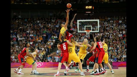 Liz Cambage of Australia attempts to control the opening tipoff against Tina Charles of the United States during the women's basketball semifinal.