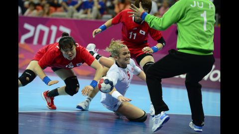 Norway left back Ida Alstad, center, vies with South Korea right back Choi Im-Jeong, left, during the women's semifinal handball match.