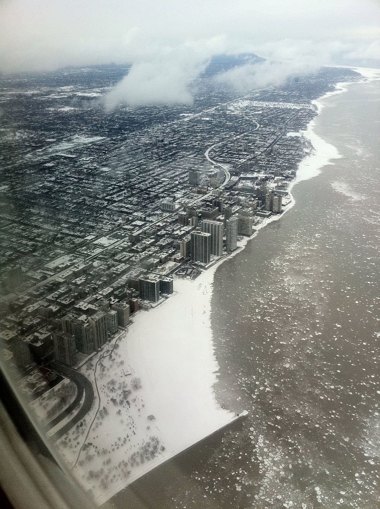 Marvin Mason took this "apocalyptic" shot of Chicago flying over Lake Michigan. "The icy waters added to the drama."