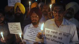 Members of the Akhil Bharatiya Human Rights Organization hold placards and candles during a vigil in Amritsar, India, on Tuesday, August 7, as they pay tribute to Sikh devotees killed in the U.S. The tragedy of the Wisconsin Sikh temple shooting has reverberated worldwide. 