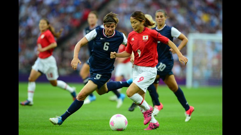 U.S. defender Amy LePeilbet, left, fights for the ball with Japanese midfielder Nahomi Kawasumi during the final of the women's football competition.