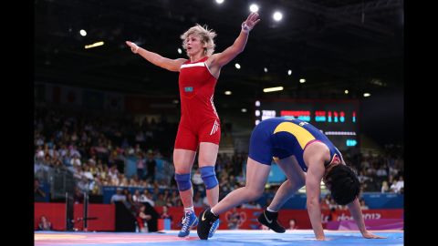 Jiao Wang of China, in blue, and Guzel Manyurova of Kazakhstan compete in the women's freestyle 72-kilogram wrestling.