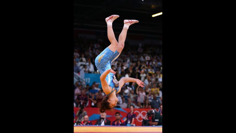 Saori Yoshida of Japan celebrates winning the gold medal over Tonya Lynn Verbeek of Canada in the women's freestyle 55-kilogram wrestling.