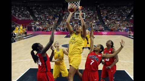Australia's Liz Cambage, center, shoots over Maya Moore, right, and Tina Charles of the USA.