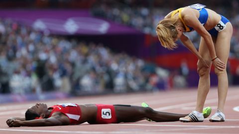 Alysia Johnson Montano of the United States lies on the ground next to Elena Mirela Lavric of Romania after the women's 800-meter semifinals.
