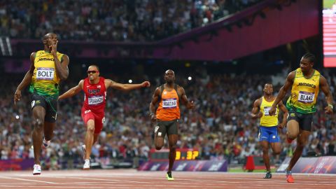 Usain Bolt of Jamaica celebrates as he crosses the finish line ahead of Wallace Spearmon of the United States, Churandy Martina of Netherlands, Yohan Blake of Jamaica and Alex Quinonez of Ecuador to win gold in the men's 200-meter final.
