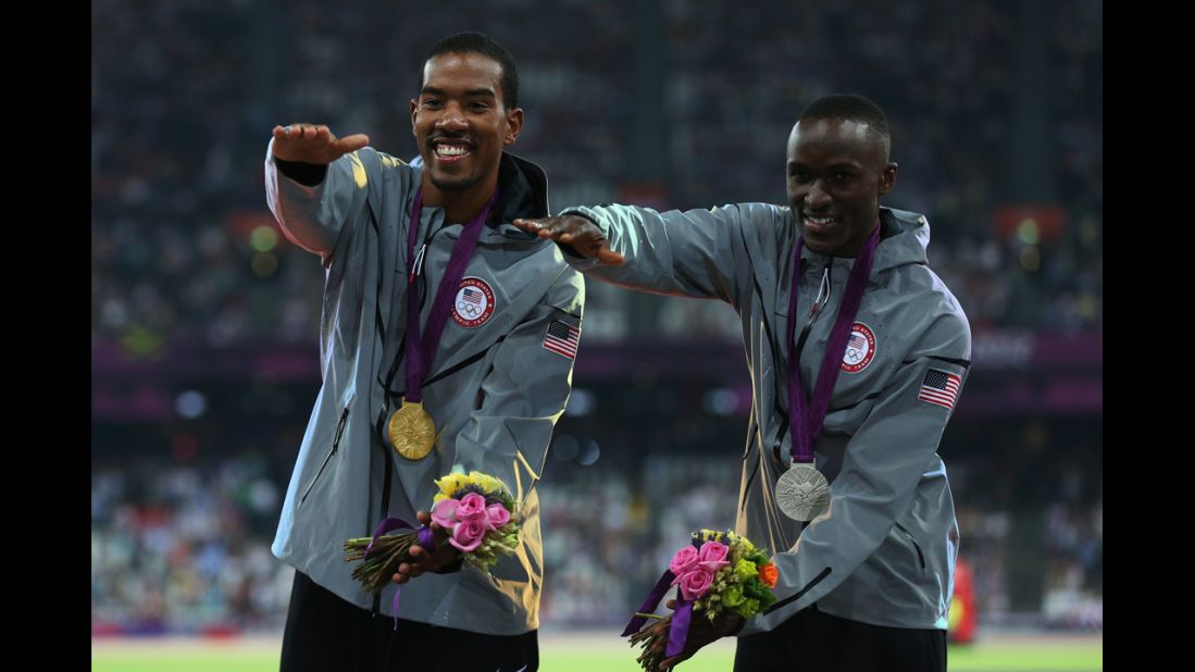 Gold medalist Christian Taylor and silver medalist Will Claye, also of the United States, celebrate during the medal ceremony for the men's triple jump. Both athletes attended the University of Florida and are seen doing the "Gator chomp."