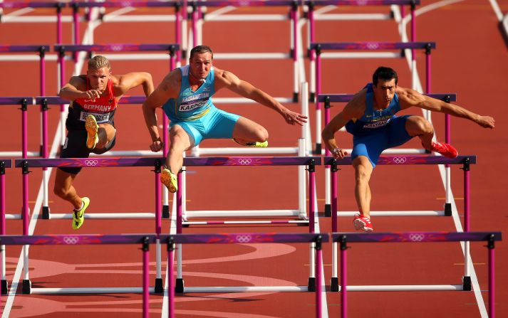 From left, Pascal Behrenbruch of Germany, Dmitriy Karpov of Kazakhstan and Oleksiy Kasyanov of Ukraine race during the men's decathlon 110-meter hurdles heats.