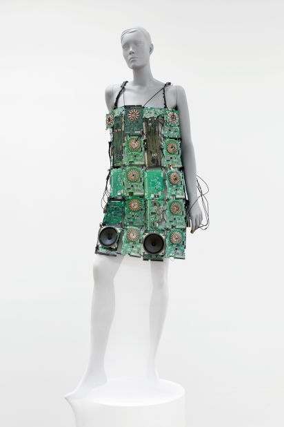This wearable musical instrument is made from 35 circuit boards. It incorporates 12 coils, which create sounds when connected through copper plates on the wearer's fingers. The battery-powered dress includes two speakers.
