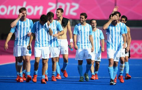 Argentina players walk off the field after losing the men's field hockey match to New Zealand 3-1.