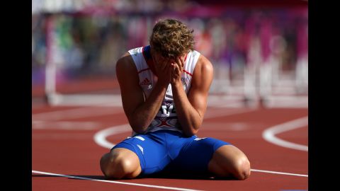 Kevin Mayer of France sits on the track after finishing last in heat 3 of the men's decathlon 110-meter hurdles.