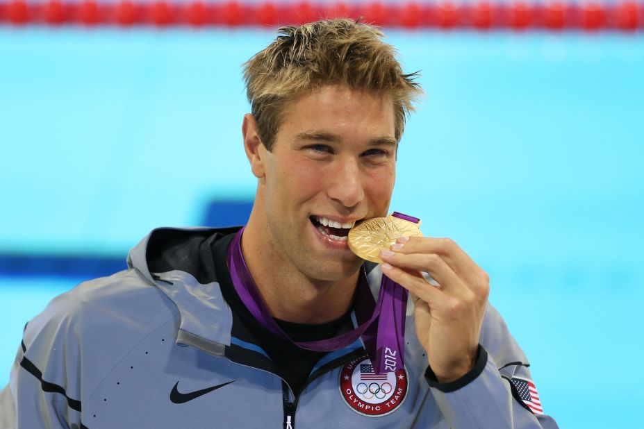 Matt Grevers of the U.S. celebrates with his gold medal during the medal ceremony for the men's 100-meter backstroke.