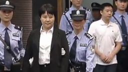 This frame grab taken from CCTV video shows Gu Kailai (2nd L), the wife of disgraced Chinese politician Bo Xilai, being excorted into the court room for her murder trial in Hefei on August 9, 2012. Gu went on trial on August 9 accused of murdering British businessman Neil Heywood in a case that has rocked the Communist party as it gears up for a leadership change.