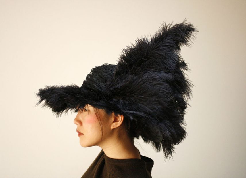 "Taiknam Hat" is designed to respond to changes in surrounding radio signals. A detection system measures medium-wave radio signals and passes on the information to a microcomputer. The computer then activates motors that move the feathers adorning the hat.  "Our intention is to ... contribute to our awareness of the increasing level of electromagnetic radiation in our environment," say its designers.