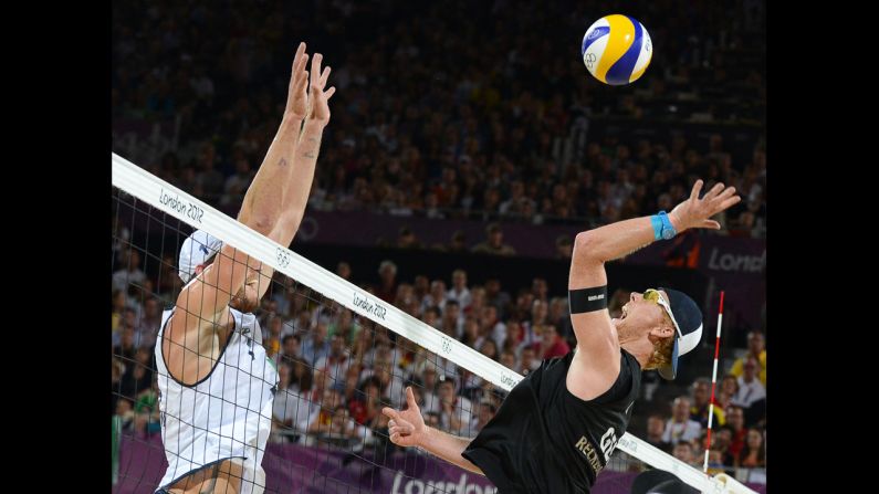 Germany's right blocker Jonas Reckermann, right, jumps  in front of Brazil's left blocker Alison Cerutti, left, during the men's beach volleyball final match on Thursday, August 9, in London. <a >Check out Day 12 of competition</a> from Wednesday, August 8. The Games ran through Sunday.
