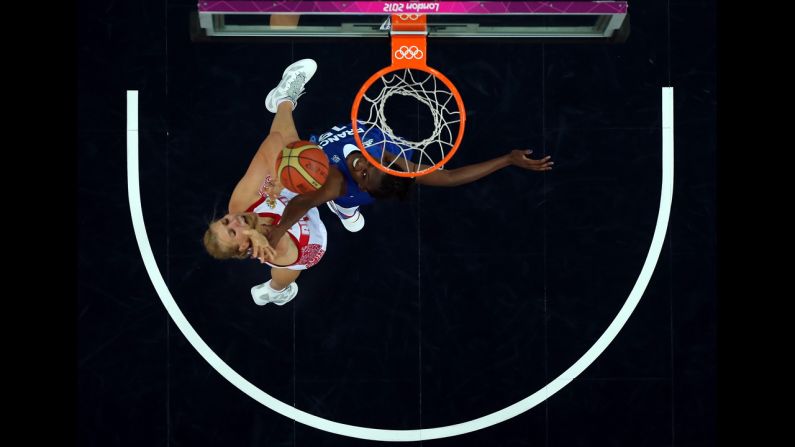 Natalia Vieru, No.11 of Russia, puts up a shot over Jennifer Digbeu, No.15 of France, during the women's basketball semifinal.