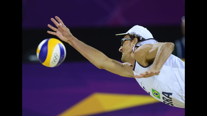 Brazil's right defender Emanuel Rego jumps to return the ball during the men's beach volleyball final match against Germany.
