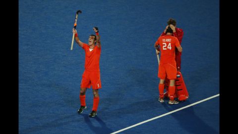 Marcel Balkestein, Robert van der Horst and goalkeeper Jaap Stockman of the Netherlands celebrate victory after the men's hockey semifinal match between Great Britain and the Netherlands.