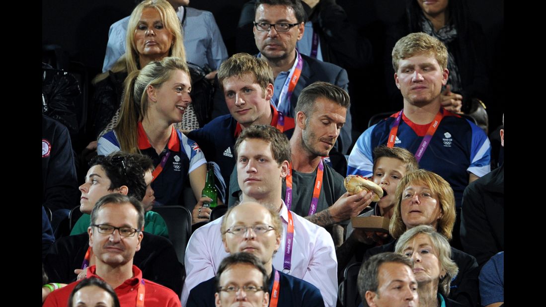 From left, British cyclists Laura Trott and Jason Kenny and  David and Romeo Beckham watch the beach volleyball.