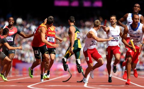 South Africa's Oscar Pistorius, center, waits for the baton during the men's 4 x 400-meter relay round 1 heats. Pistorius made history when he became the first double amputee athlete to compete in the Olympics.