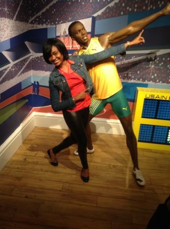 Ehimhen Okoh is on vacation in London and had her boyfriend shoot this picture of her at Madame Tussauds wax museum in front of Usain Bolt's new statue.<br />