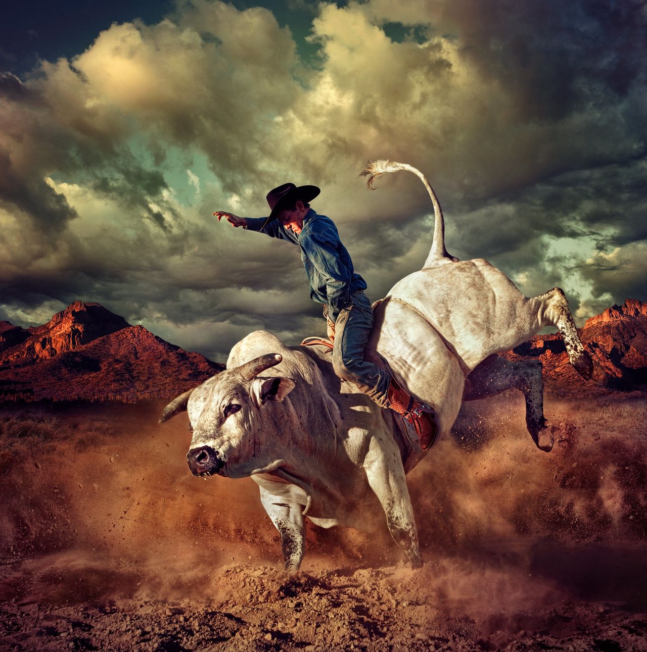 Chris Clor's dramatic photograph of this bull rider won the Communication Arts Photography Competition. Combining separate shots of the bull, the rider, Superstition Mountains and the sky, he knitted them together in Photoshop. Although it was shot for a client selling boots, the image represents a possible reality because of Clor's composition.