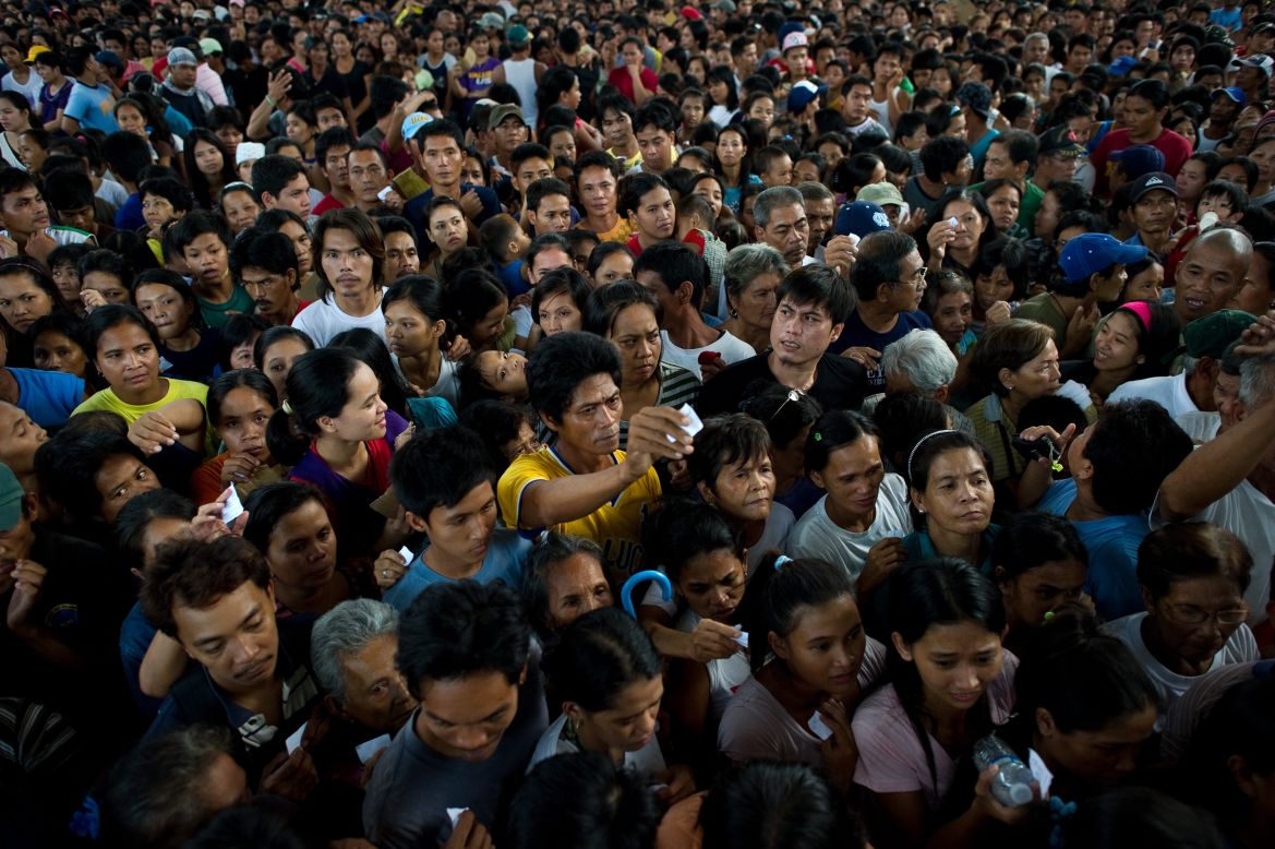 Thousands line up for food relief Friday in Paombong outside Manila.