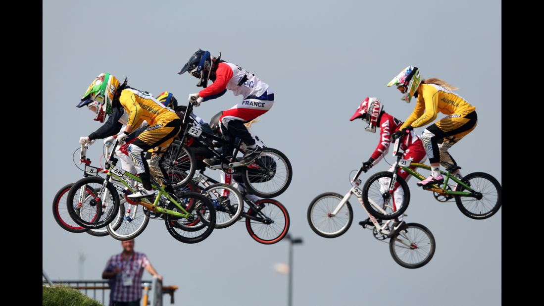 Cyclists make a jump during the women's BMX cycling semifinals.