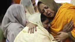 OAK CREEK - AUGUST 10: Two woman hug as community members pay respects to the six victims in the mass shooting at the Sikh Temple of Wisconsin, at the Oak Creek High School August, 10, 2012 Oak Creek Wisconsin. Suspected gunman, 40-year-old Wade Michael Page, allegedly killed six people at the temple on August 5 and then killed himself at the scene. He was an army veteran and reportedly a former member of a white supremacist heavy metal band. Three others were critically wounded in the attack.  (Photo by Darren Hauck/Getty Images)