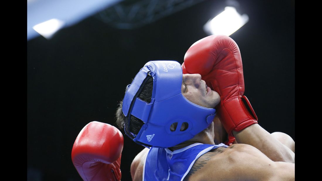 Italy's Vincenzo Mangiacapre, left, faces off against Roniel Iglesias Sotolongo of Cuba in the men's light welterweight (64-kilogram) boxing semifinals.