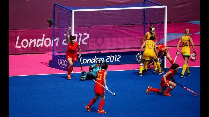 China's Qingling Song, left, celebrates a disallowed goal in the women's field hockey classification match against Australia.