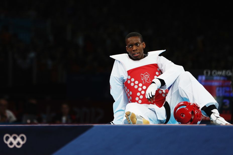 Great Britain's Lutalo Muhammad appears dejected after losing to Nicolas Garcia Hemme of Spain during the men's under 80-kilogram taekwondo quarterfinal.