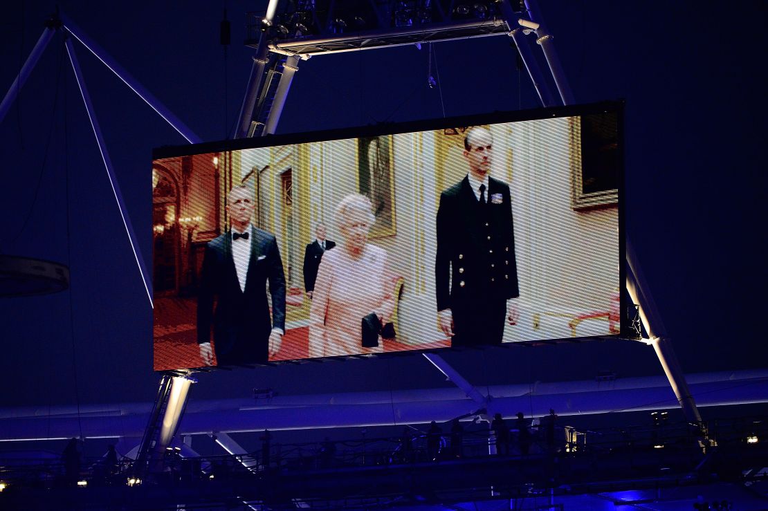 Queen Elizabeth II appears on a large video screen accompanied by Bond actor Daniel Craig during the Opening Ceremony for the 2012 Summer Olympic Games in London.  