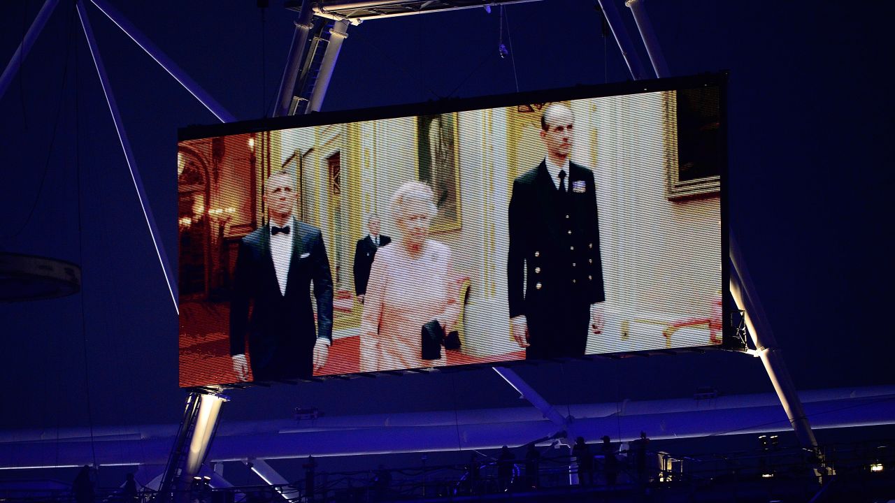 Queen Elizabeth II appears on a large video screen accompanied by Bond actor Daniel Craig during the Opening Ceremony for the 2012 Summer Olympic Games in London.  
