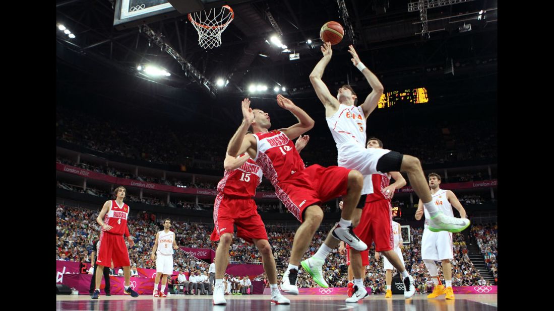 No. 15 Rudy Fernandez goes up for a shot against No. 12 Sergey Monya of Russia in the first half during the men's basketball semifinal match.
