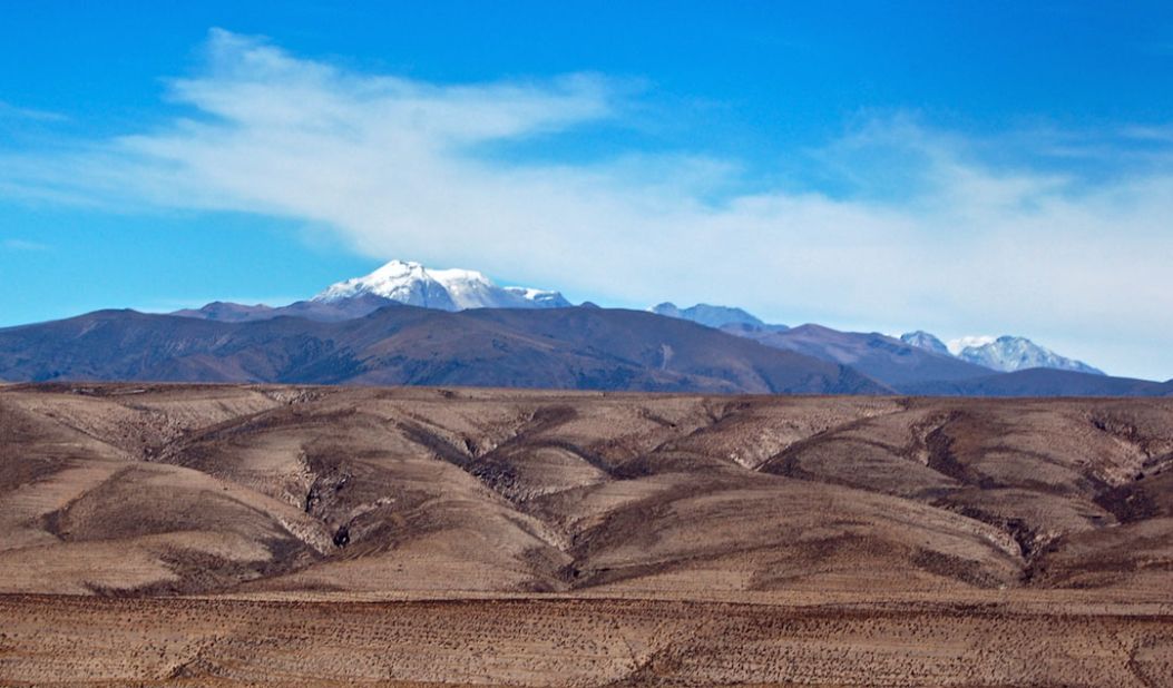 <a href="http://ireport.cnn.com/docs/DOC-825313">John Vogel</a> was on a minibus traveling between the city of Arequipa and Colca Canyon in Peru when he saw this odd landscape. "Looking at the photo now, it almost looks like two photos combined into one photo. That's how great I find the contrast between the dark rocky foreground and the bright blue sky with the snow-capped volcano."